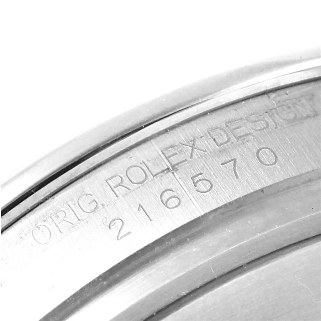 The image shows a close-up of the serial number and "ORIG. ROLEX DESIGN" engraving on a Rolex Explorer 216570 Men's Stainless Steel Black Dial 216570 Men's Stainless Steel Black Dial watch casing.