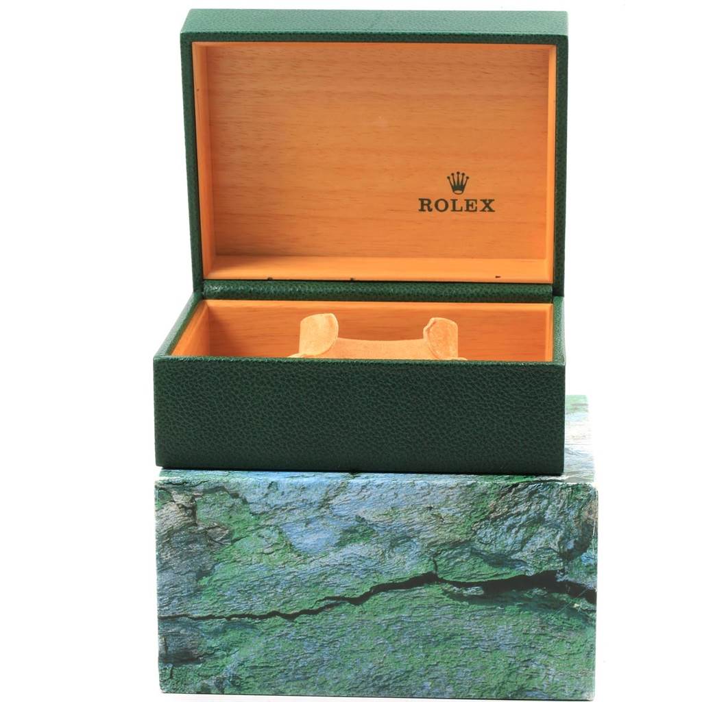 The image shows an open Rolex Explorer 16570 Men's Stainless Steel White Dial 16570 Men's Stainless Steel White Dial watch box with a green exterior, wood interior, and Rolex branding inside the lid.