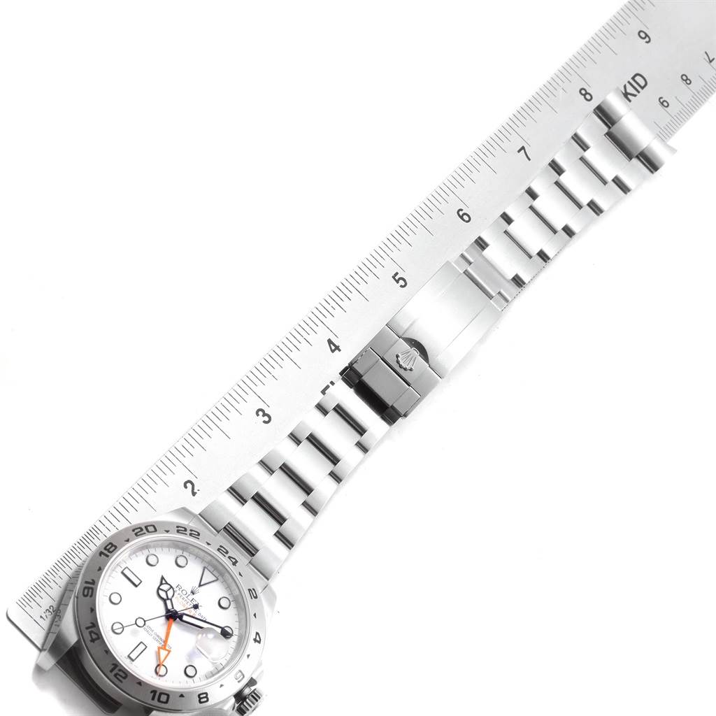 The image shows a Rolex Explorer 216570 Men's Stainless Steel White Dial 216570 Men's Stainless Steel White Dial watch laid flat with a ruler measuring its stainless steel bracelet.