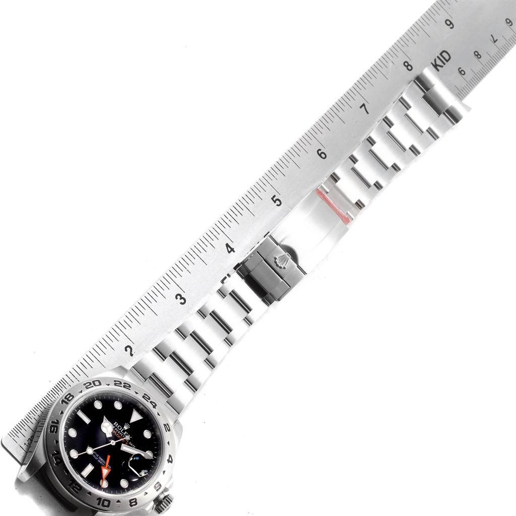 The image shows a Rolex Explorer 216570 Men's Stainless Steel Black Dial 216570 Men's Stainless Steel Black Dial watch laid flat with a measuring ruler, showing the watch face and the entire metal bracelet.