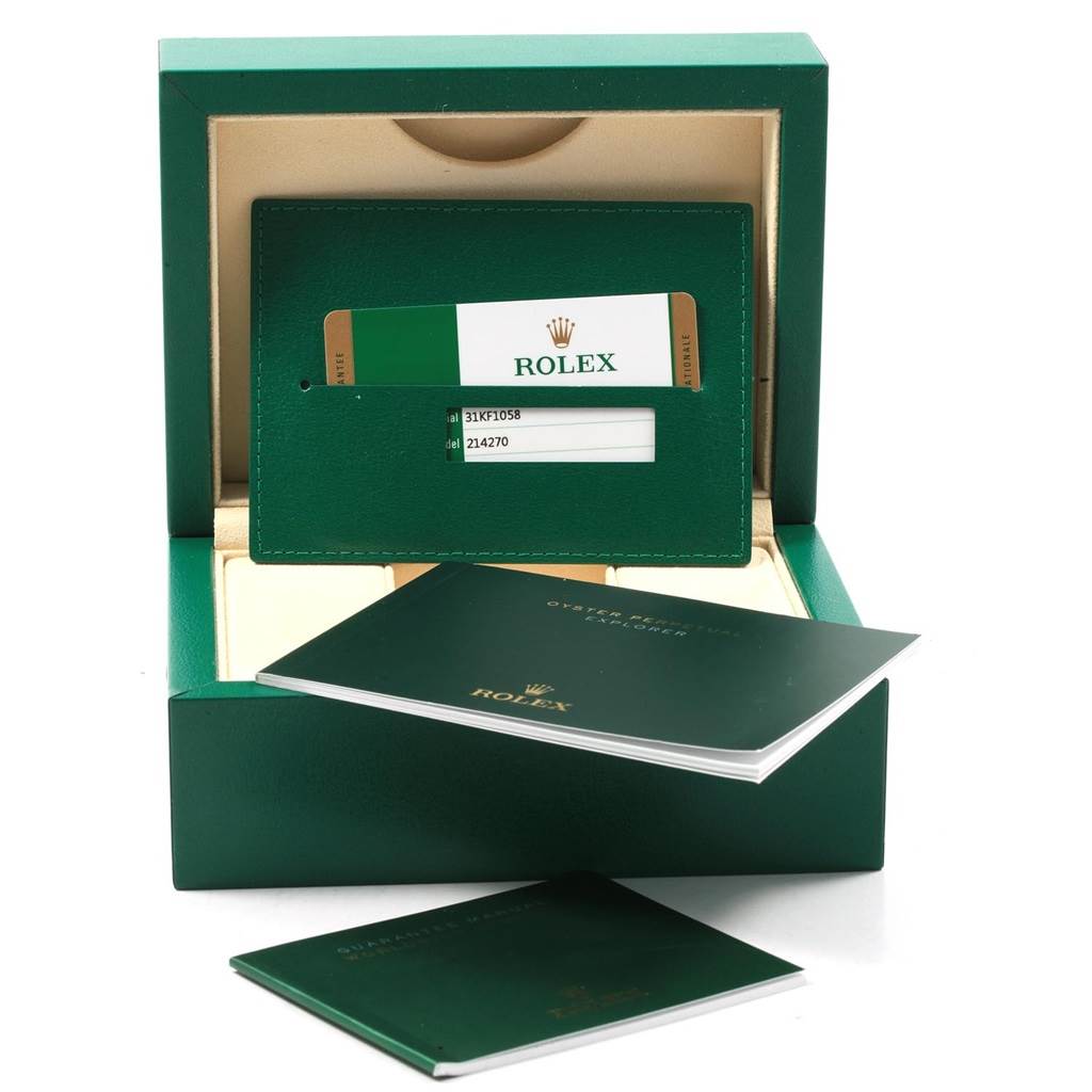 The image shows the warranty card, cardholder, and manuals inside the packaging box for a Rolex Explorer 214270 Men
s Stainless Steel Black Dial 214270 Men
s Stainless Steel Black Dial watch.