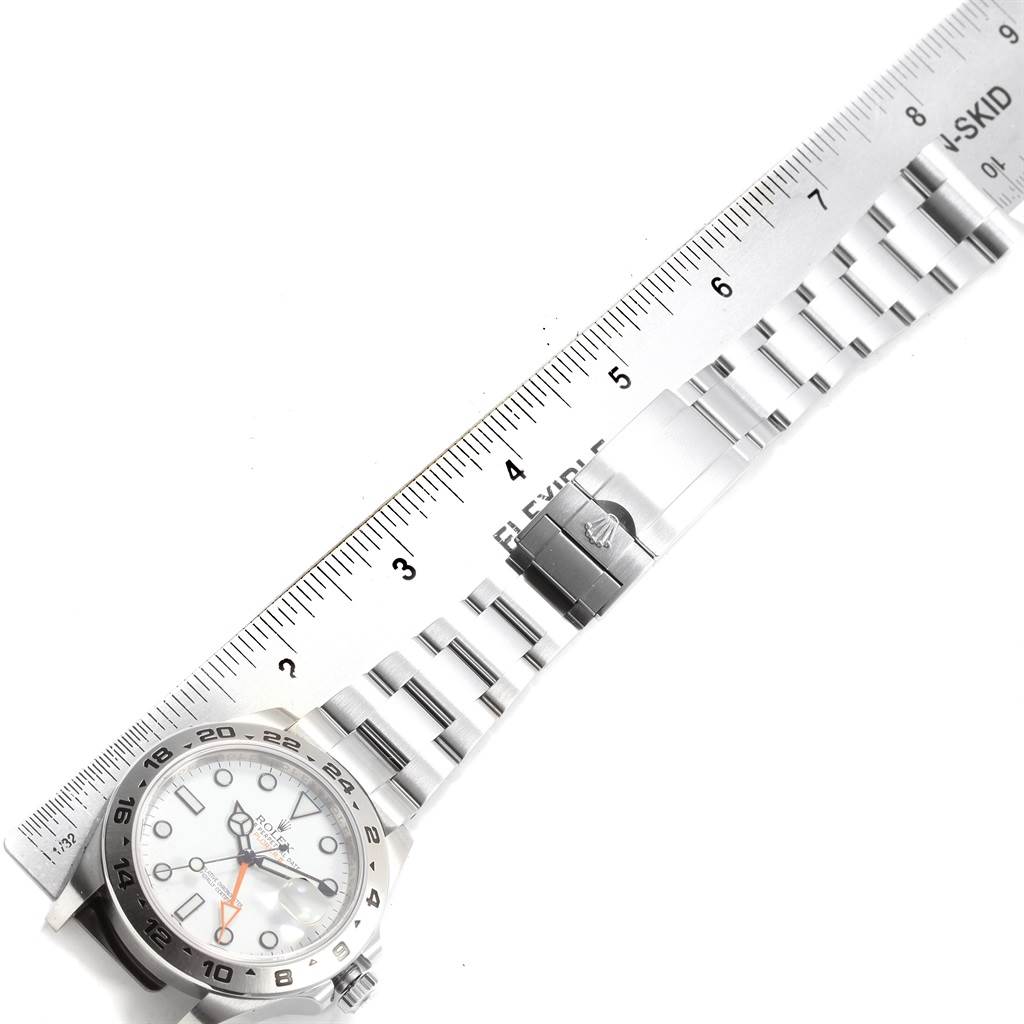 The image shows a Rolex Explorer 216570 Men's Stainless Steel White Dial 216570 Men's Stainless Steel White Dial watch laid flat next to a ruler, displaying its face, bracelet, and clasp.