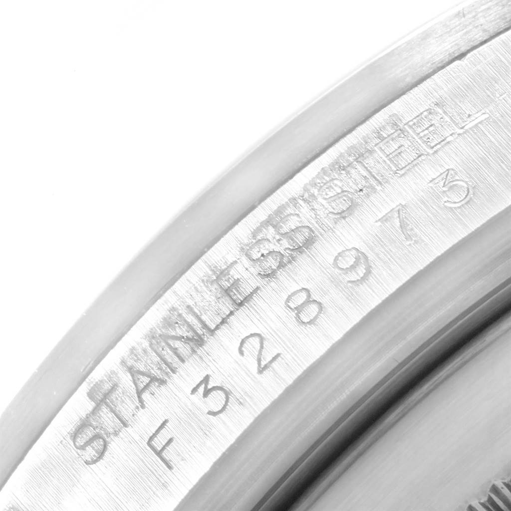 The image shows a close-up angle of the serial number and "STAINLESS STEEL" engraving on a Rolex Explorer 16570 Men's Stainless Steel White Dial 16570 Men's Stainless Steel White Dial watch.