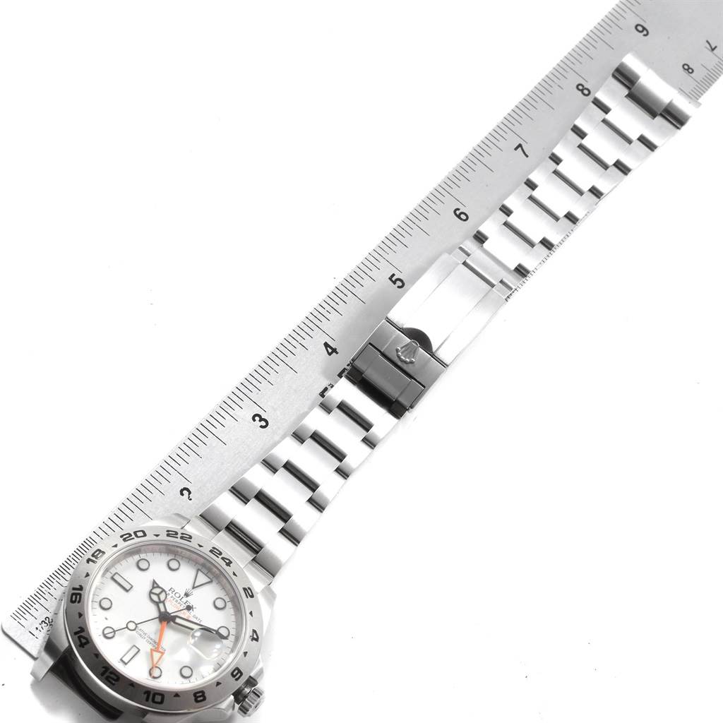 The image shows a Rolex Explorer 216570 Men's Stainless Steel White Dial 216570 Men's Stainless Steel White Dial watch laid out flat, with its full bracelet and clasp visible alongside a ruler.