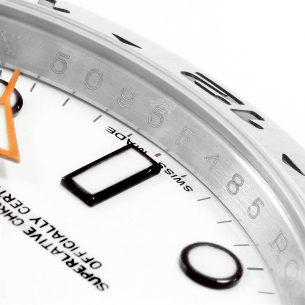 This close-up angle shows the dial, bezel, and an orange hand of the Rolex Explorer 216570 Men's Stainless Steel White Dial 216570 Men's Stainless Steel White Dial watch.