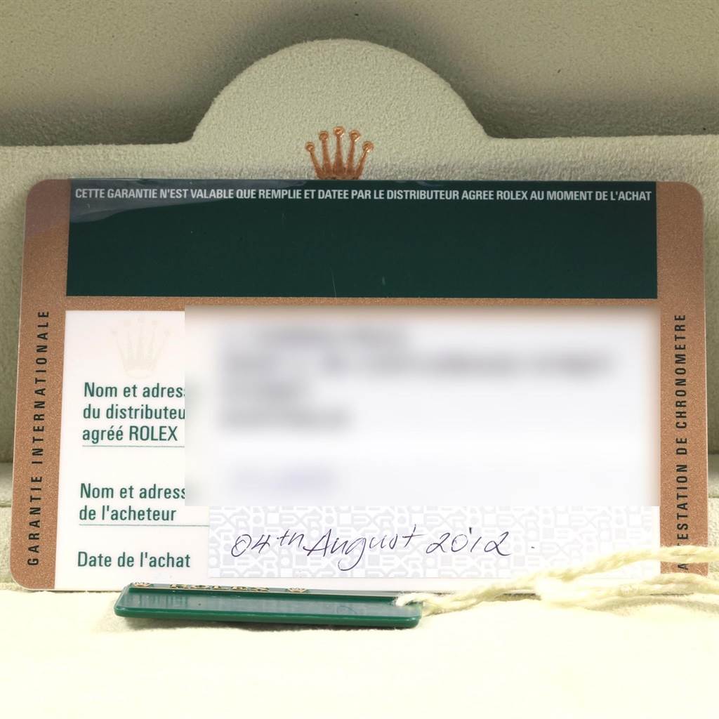 The image shows a warranty card for a Rolex Explorer 216570 Men's Stainless Steel White Dial 216570 Men's Stainless Steel White Dial model from an overhead angle, with some text blurred for privacy.