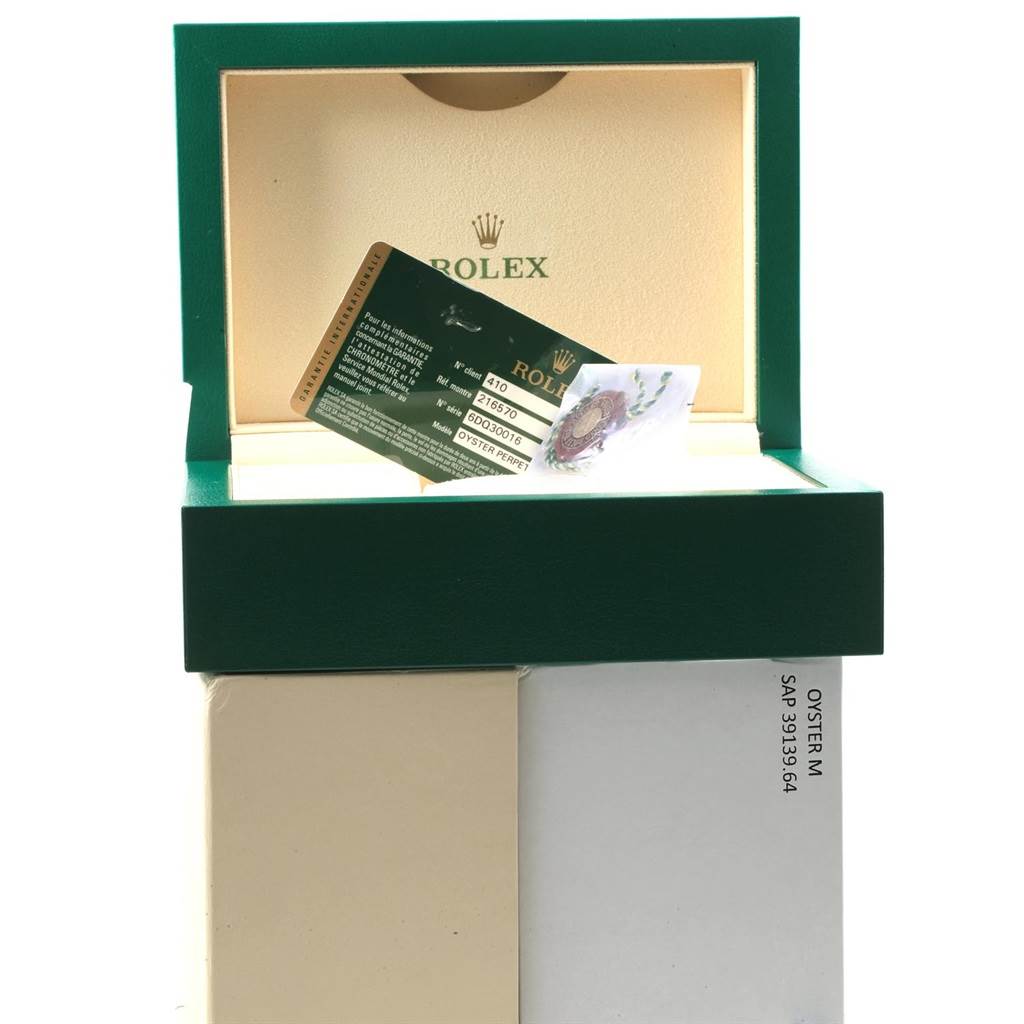 The image features an open green Rolex watch box revealing a warranty card for the Rolex Explorer 216570 Men's Stainless Steel White Dial 216570 Men's Stainless Steel White Dial model.