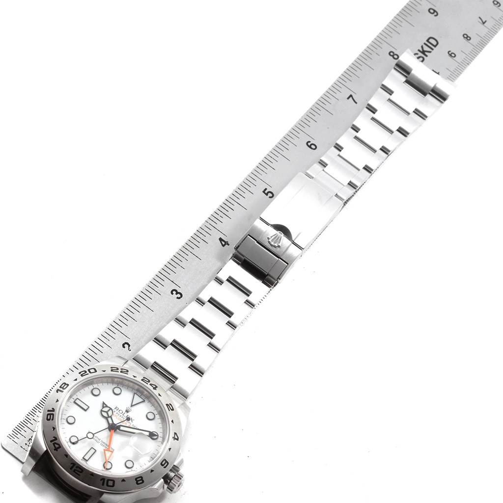 The image shows the front dial and bracelet of a Rolex Explorer 216570 Men's Stainless Steel White Dial 216570 Men's Stainless Steel White Dial watch laid alongside a ruler for measurement.