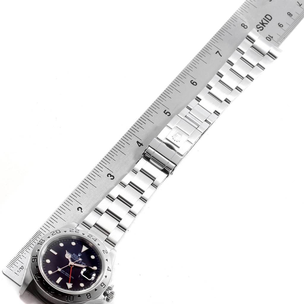 The image shows a Rolex Explorer 16570 Men's Stainless Steel Black Dial 16570 Men's Stainless Steel Black Dial watch with the bracelet and clasp measured against a ruler.