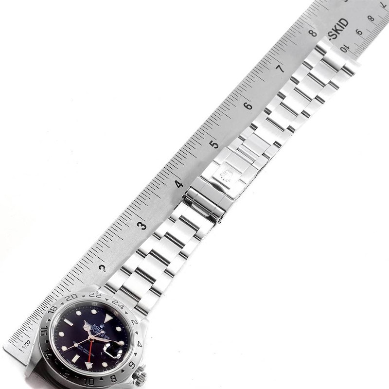 The image shows a Rolex Explorer watch with the bracelet and clasp measured against a ruler.