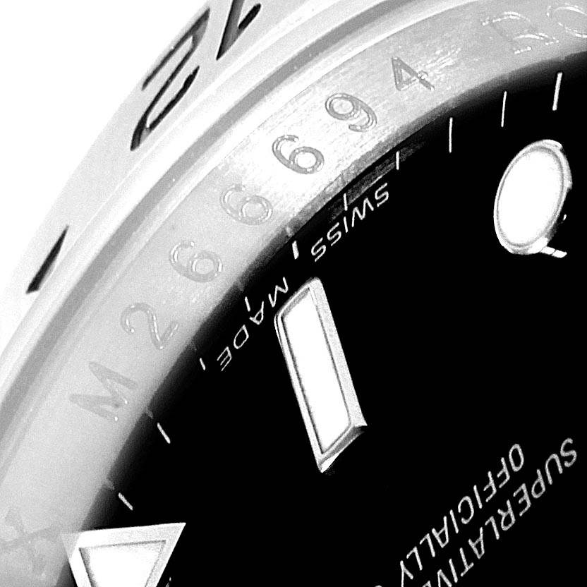 The image shows a close-up of the bezel, part of the dial, and indices of a Rolex Explorer 16570 Men's Stainless Steel Black Dial 16570 Men's Stainless Steel Black Dial watch.