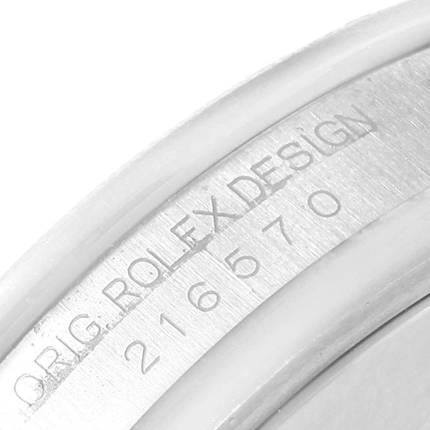 The image shows a close-up of the inner case engraving on a Rolex Explorer 216570 Men's Stainless Steel Black Dial 216570 Men's Stainless Steel Black Dial watch, displaying the model number and "Orig. Rolex Design".