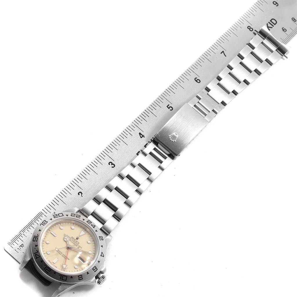 The image shows a top view of a Rolex Explorer 16550 Men's Stainless Steel Beige Dial 16550 Men's Stainless Steel Beige Dial watch with its bracelet and clasp extended, alongside a ruler for measurement.