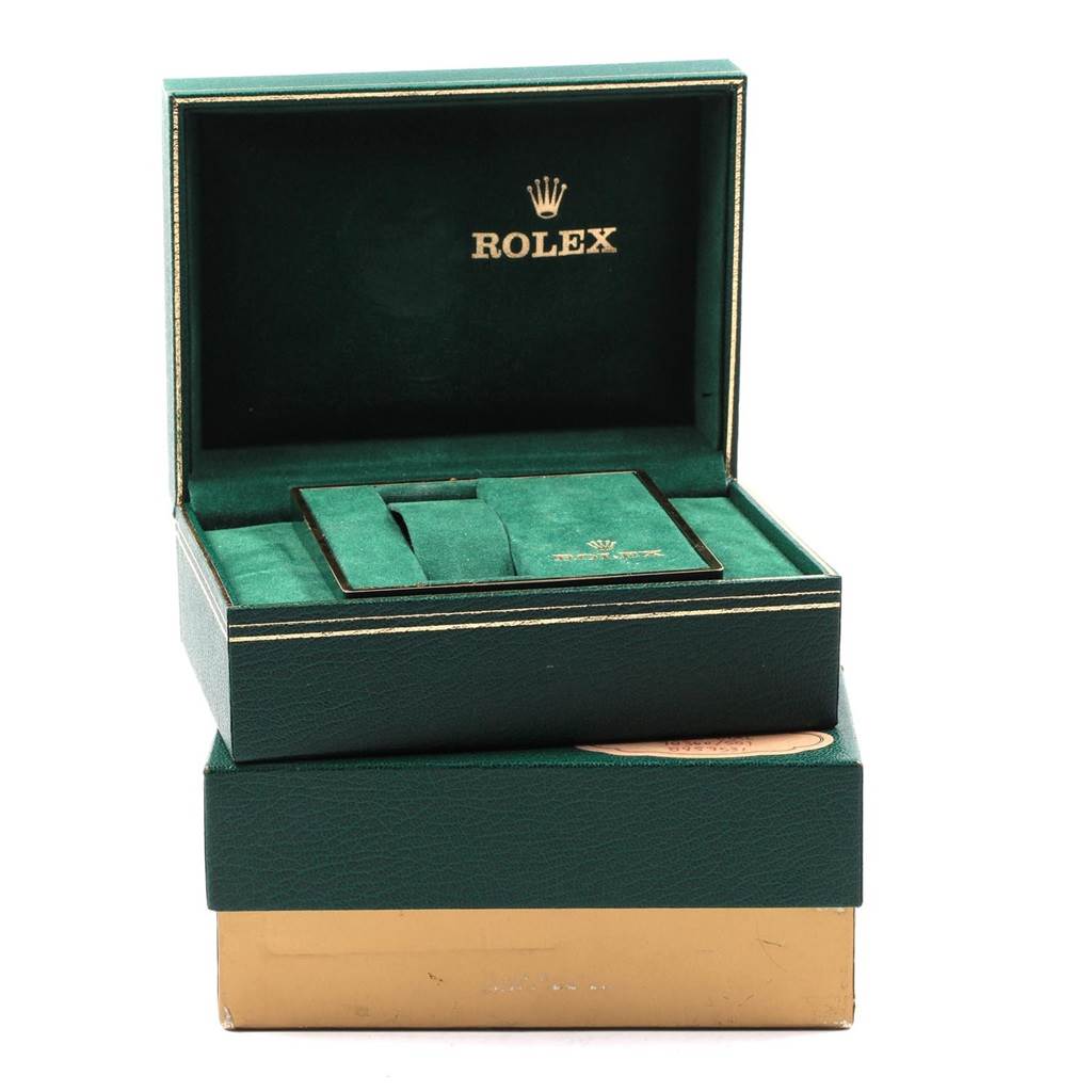 The image shows an open green Rolex box for the Explorer model, displaying the internal compartments and branding.