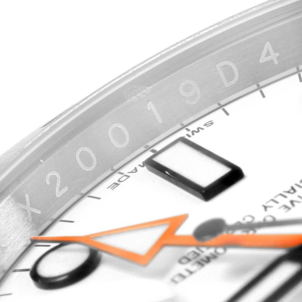 The image shows a close-up of the dial and chapter ring of the Rolex Explorer 216570 Men's Stainless Steel White Dial 216570 Men's Stainless Steel White Dial watch, revealing part of the serial number.