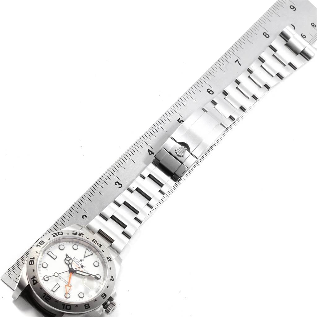 The Rolex Explorer 216570 Men's Stainless Steel White Dial 216570 Men's Stainless Steel White Dial watch is shown flat with the bracelet extended and a ruler for scale.