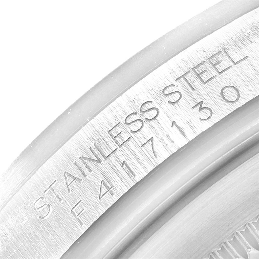 The image shows a close-up view of the stainless steel engraving on the back case rim of a Rolex Explorer 16570 Men's Stainless Steel Black Dial 16570 Men's Stainless Steel Black Dial watch.