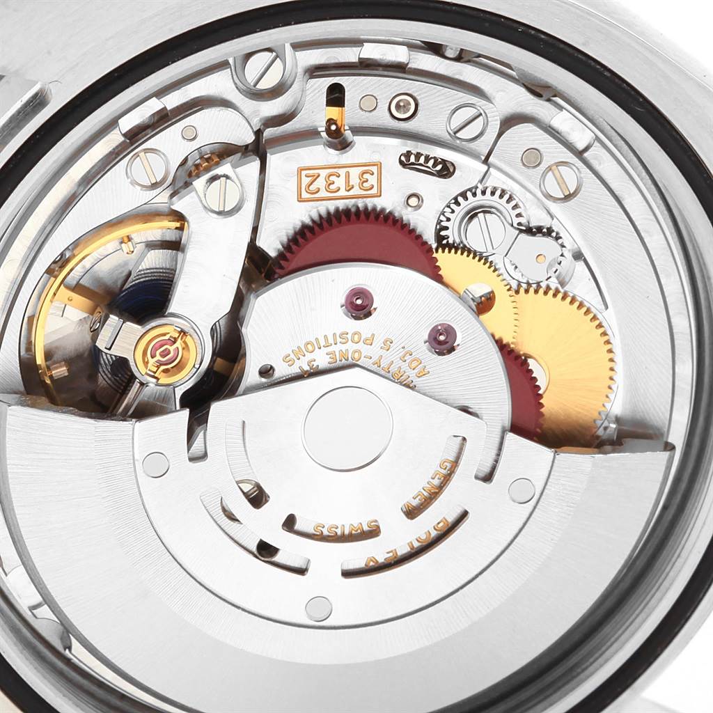 This close-up view of a Rolex Explorer 214270 Men
s Stainless Steel Black Dial 214270 Men
s Stainless Steel Black Dial watch shows its intricate mechanical movement and internal components.