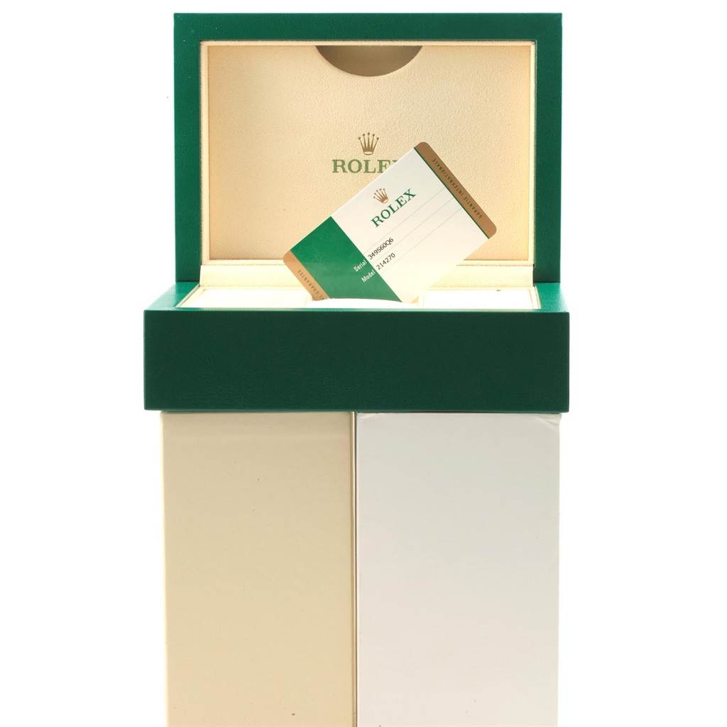 The image shows an open box of a Rolex Explorer 214270 Men
s Stainless Steel Black Dial 214270 Men
s Stainless Steel Black Dial watch, displaying the warranty card inside.