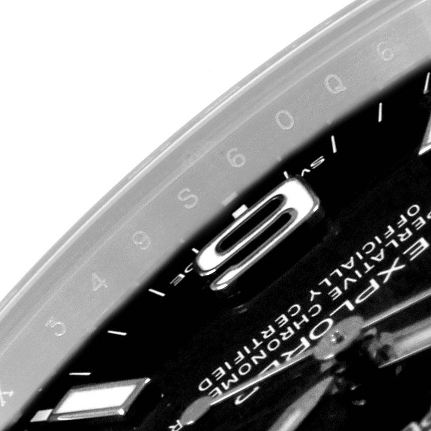 Close-up shot of the dial and part of the bezel of a Rolex Explorer 214270 Men
s Stainless Steel Black Dial 214270 Men
s Stainless Steel Black Dial watch, featuring the 
9
 numeral marker.