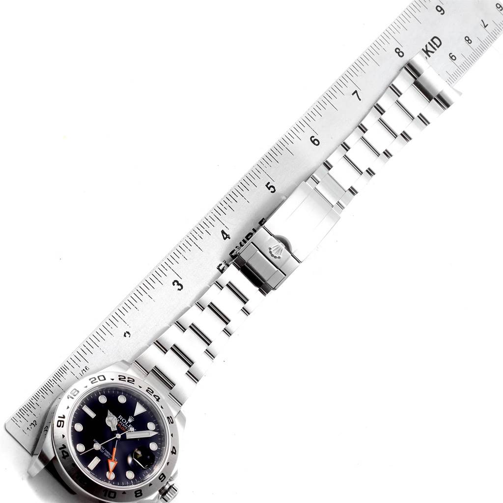 The image shows a Rolex Explorer 216570 Men's Stainless Steel Black Dial 216570 Men's Stainless Steel Black Dial watch laid flat with a ruler measuring its band length.