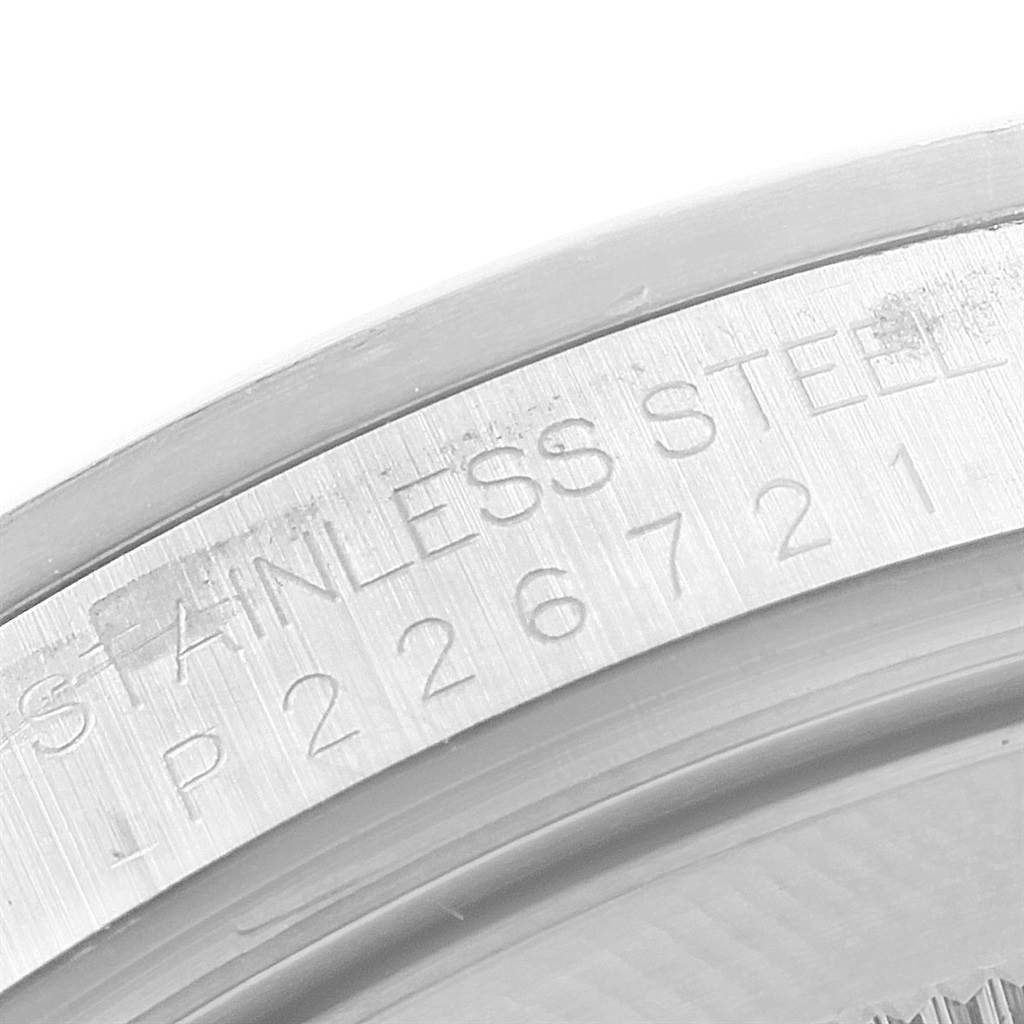 The image shows a close-up of the bezel and part of the case back with "STAINLESS STEEL" engraved on a Rolex Explorer 16570 Men's Stainless Steel White Dial 16570 Men's Stainless Steel White Dial watch.