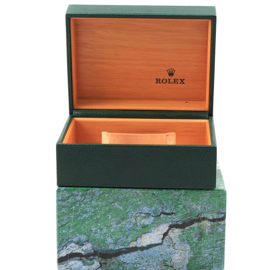 The image shows an open green Rolex box, likely meant for the Explorer model watch, with a wooden interior and a logo.