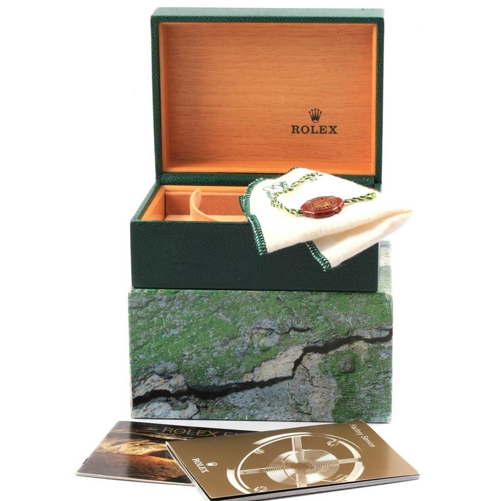 The image shows an open Rolex Explorer 16570 Men's Stainless Steel White Dial 16570 Men's Stainless Steel White Dial watch box with a cloth, tag, and manuals displayed at an angle.