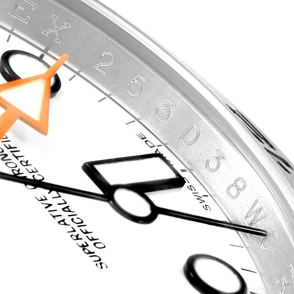 The image shows a close-up of the face and hands of a Rolex Explorer 216570 Men's Stainless Steel White Dial 216570 Men's Stainless Steel White Dial watch, highlighting its details and craftsmanship.