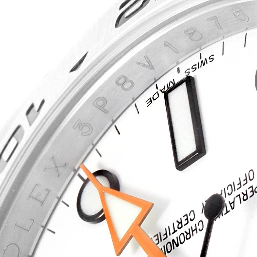 This close-up angle shows the dial and chapter ring of the Rolex Explorer 216570 Men
s Stainless Steel White Dial 216570 Men
s Stainless Steel White Dial, highlighting the orange GMT hand and "Swiss Made" text.