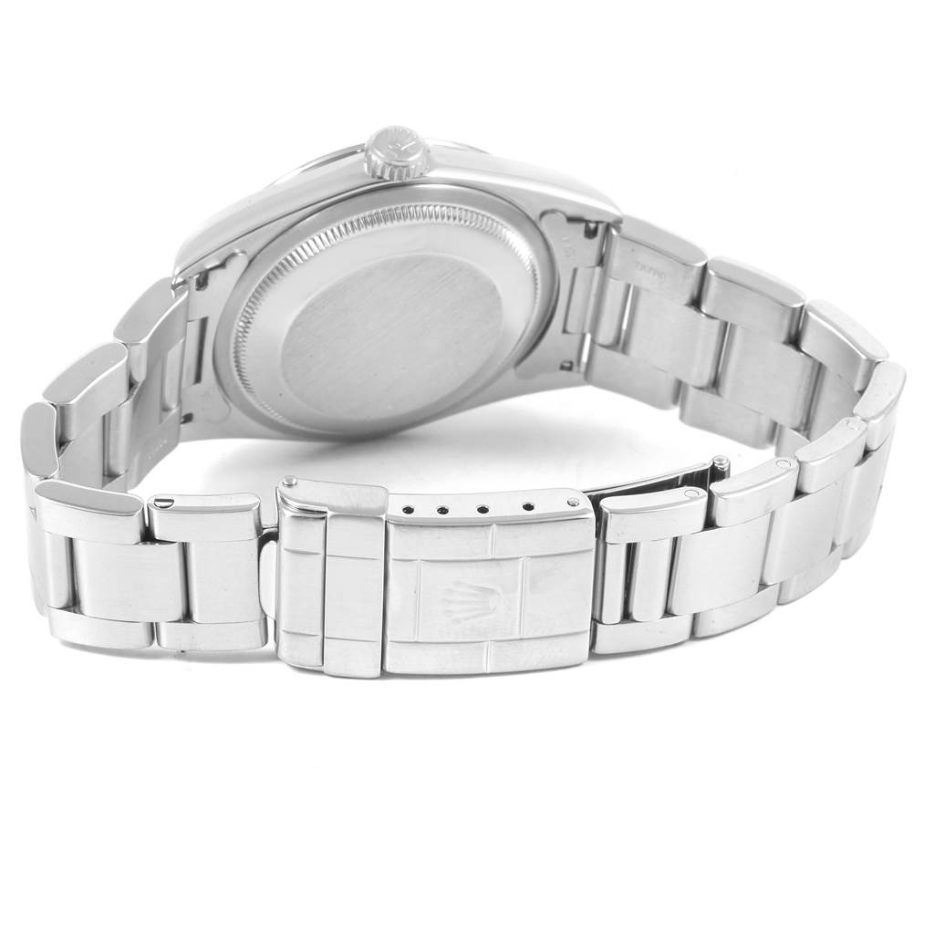 The image shows the backside of the Rolex Explorer 14270 Men
s Stainless Steel Black Dial 14270 Men
s Stainless Steel Black Dial, focusing on the case back, crown, and stainless steel bracelet with the clasp.