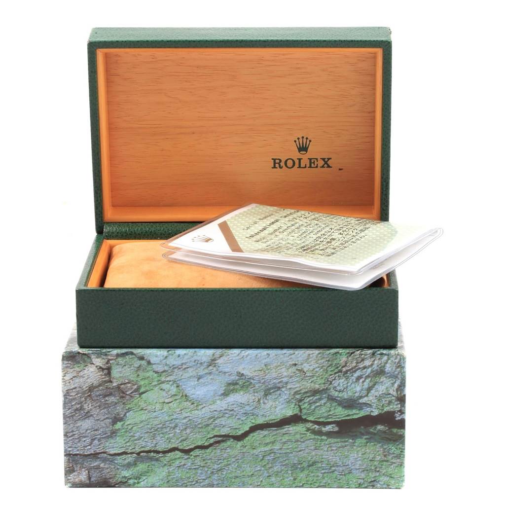 The image shows an open Rolex Explorer 14270 Men
s Stainless Steel Black Dial 14270 Men
s Stainless Steel Black Dial box with an open booklet and a pillow inside.