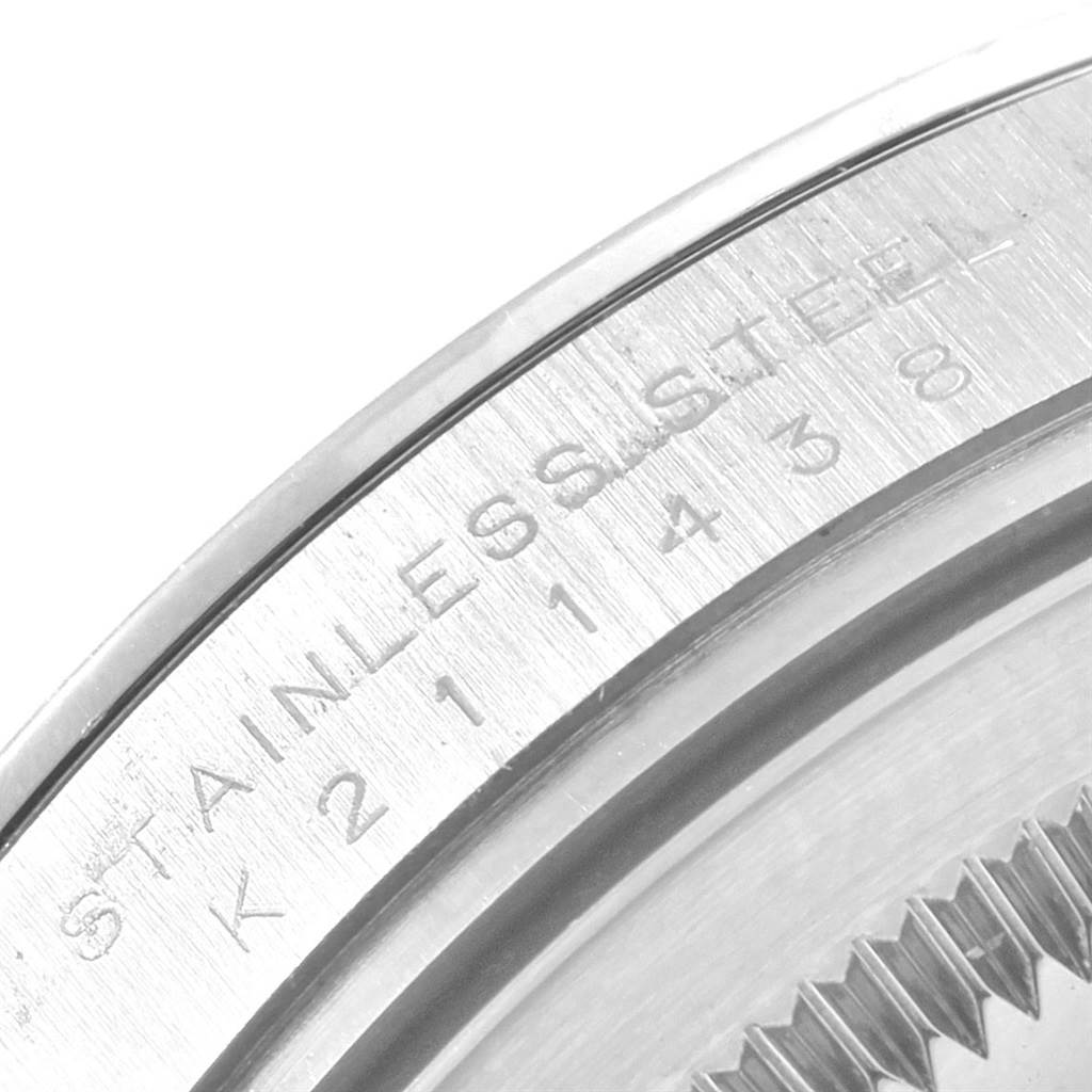 The image shows a close-up of the stainless steel case back with engravings of the Explorer model by Rolex.