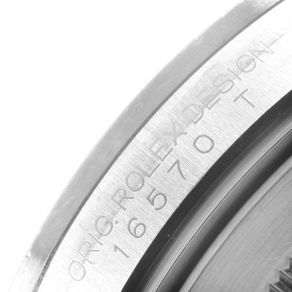 The image shows a close-up of the case back edge of a Rolex Explorer 16570 Men's Stainless Steel White Dial 16570 Men's Stainless Steel White Dial watch with the engraved text "ORIG. ROLEX DESIGN 16570 T."