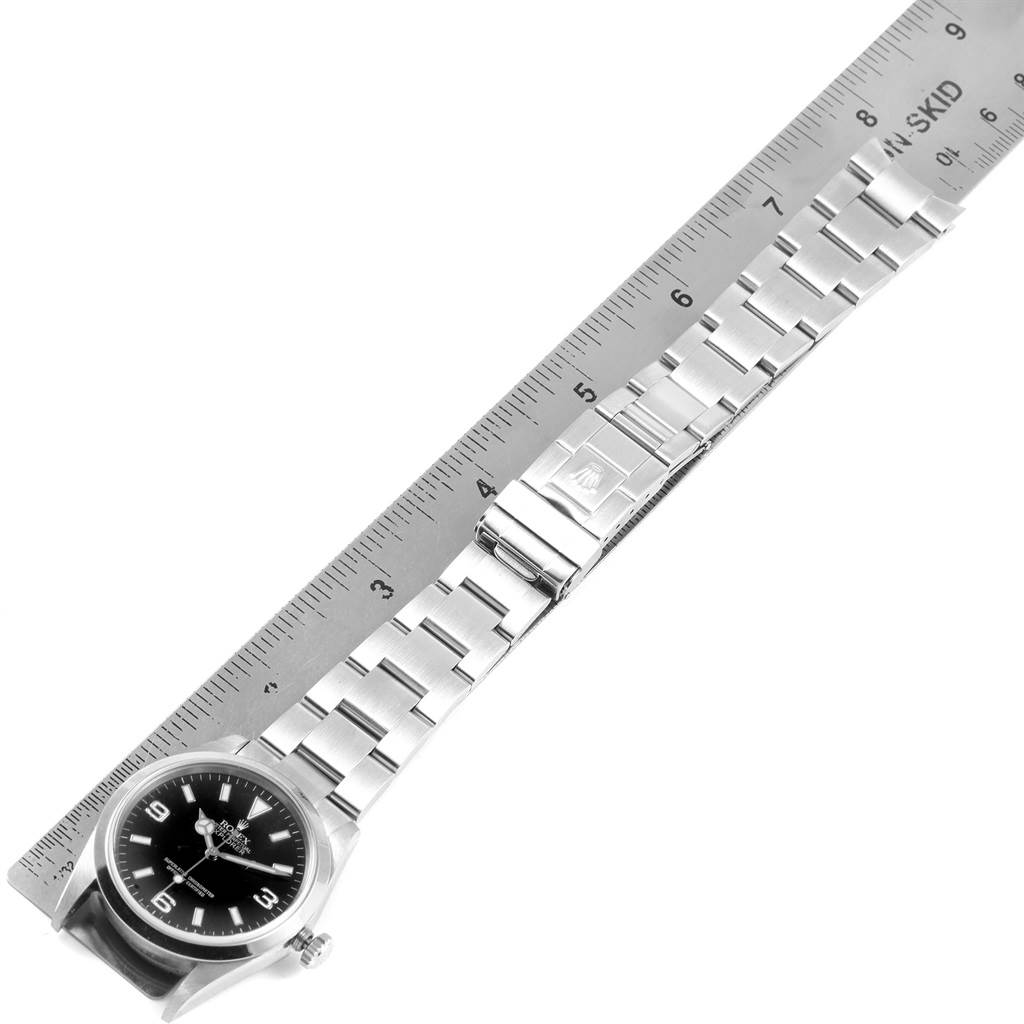 The Rolex Explorer 114270 Men's Stainless Steel Black Dial 114270 Men's Stainless Steel Black Dial watch is shown from an overhead angle, showcasing the face, bezel, bracelet, and clasp.