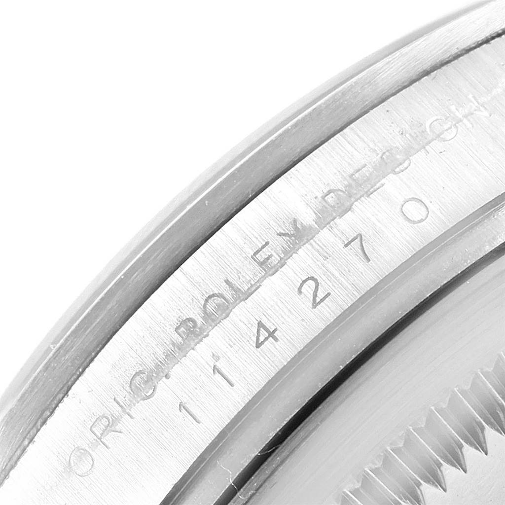 This image shows a close-up angled view of the engraved bezel and casing of a Rolex Explorer 114270 Men's Stainless Steel Black Dial 114270 Men's Stainless Steel Black Dial watch.