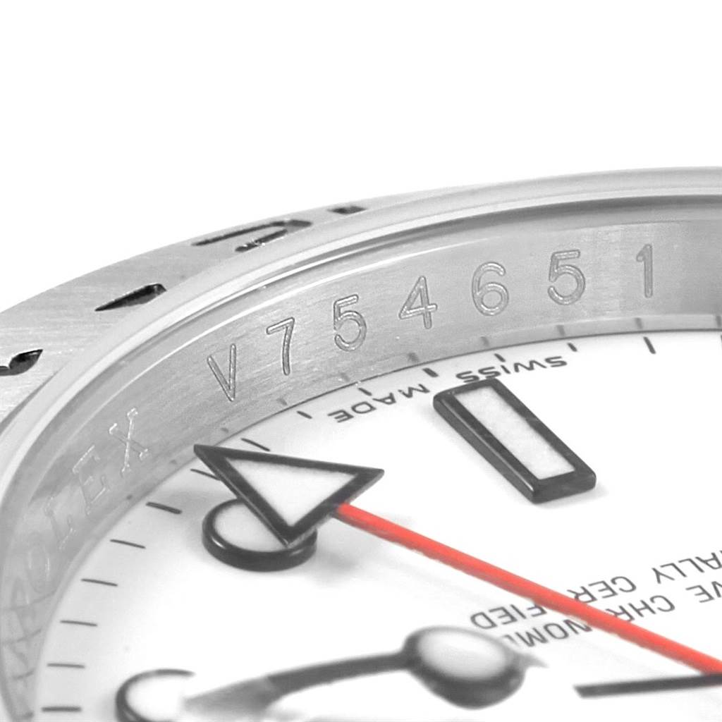 This close-up image of the Rolex Explorer 16570 Men
s Stainless Steel White Dial 16570 Men
s Stainless Steel White Dial watch shows part of the serial number, bezel, and dials.