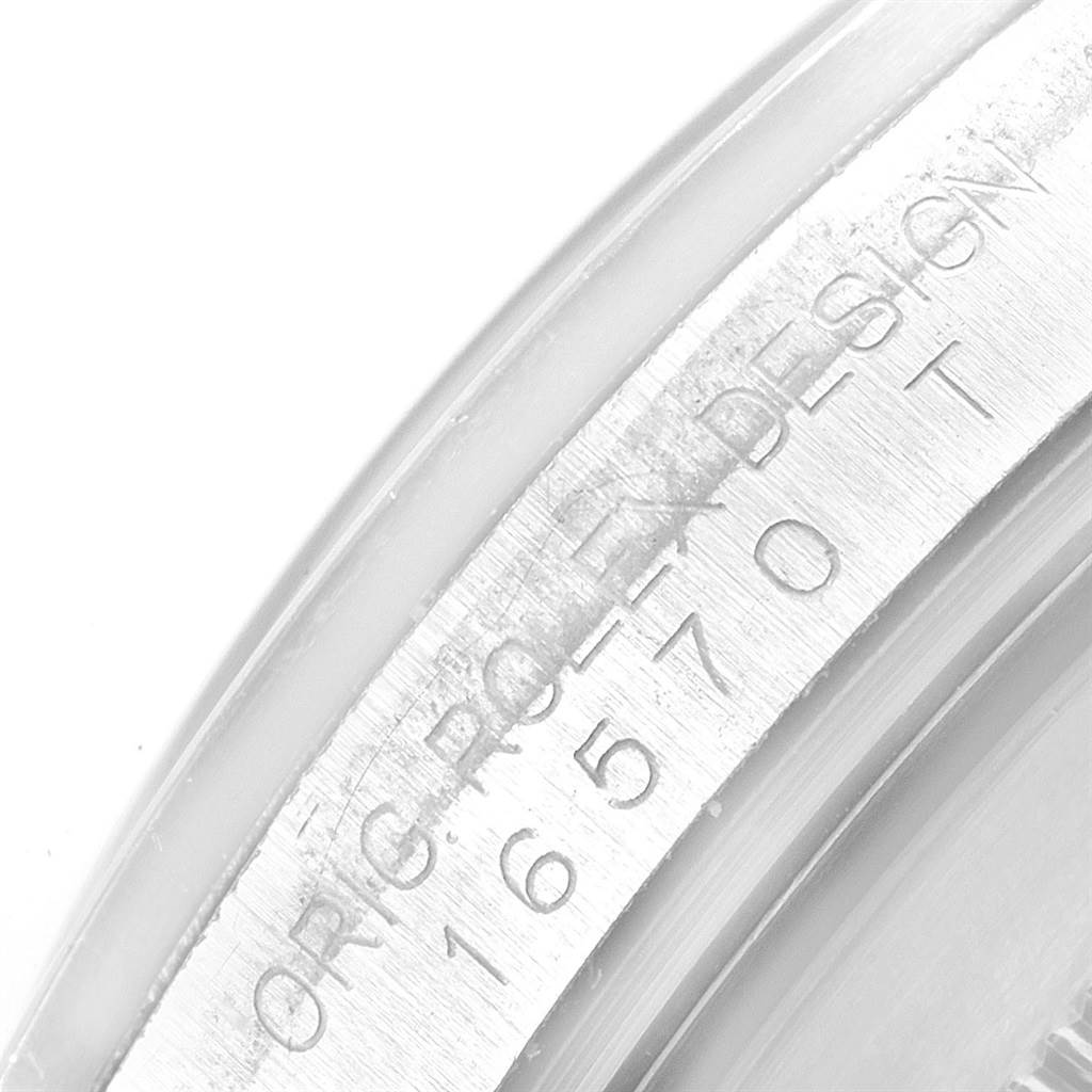 The image shows a close-up of the engraved inner bezel of the Rolex Explorer 16570 Men
s Stainless Steel White Dial 16570 Men
s Stainless Steel White Dial watch.