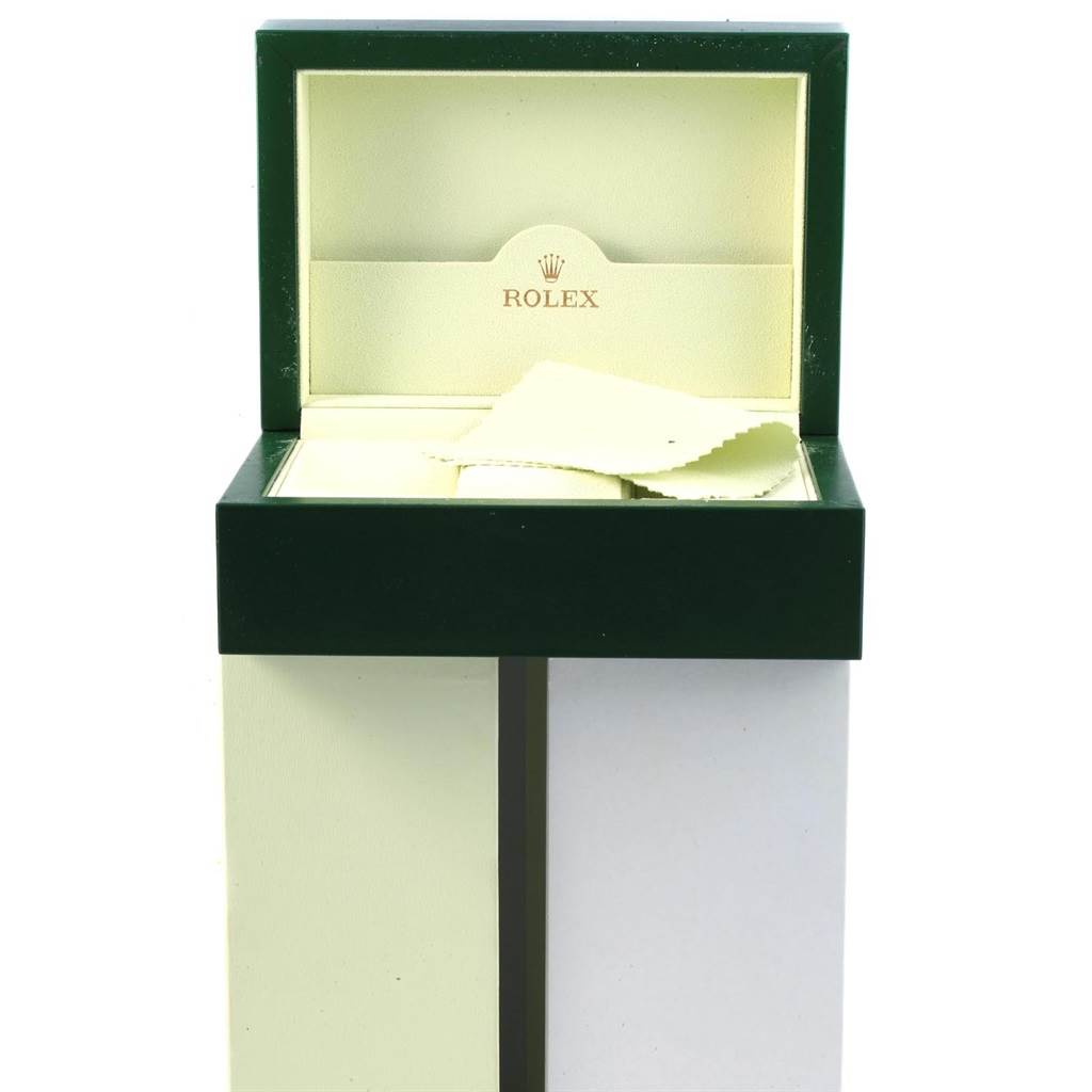 The image shows an open Rolex watch box for the Explorer model, including a cleaning cloth inside.