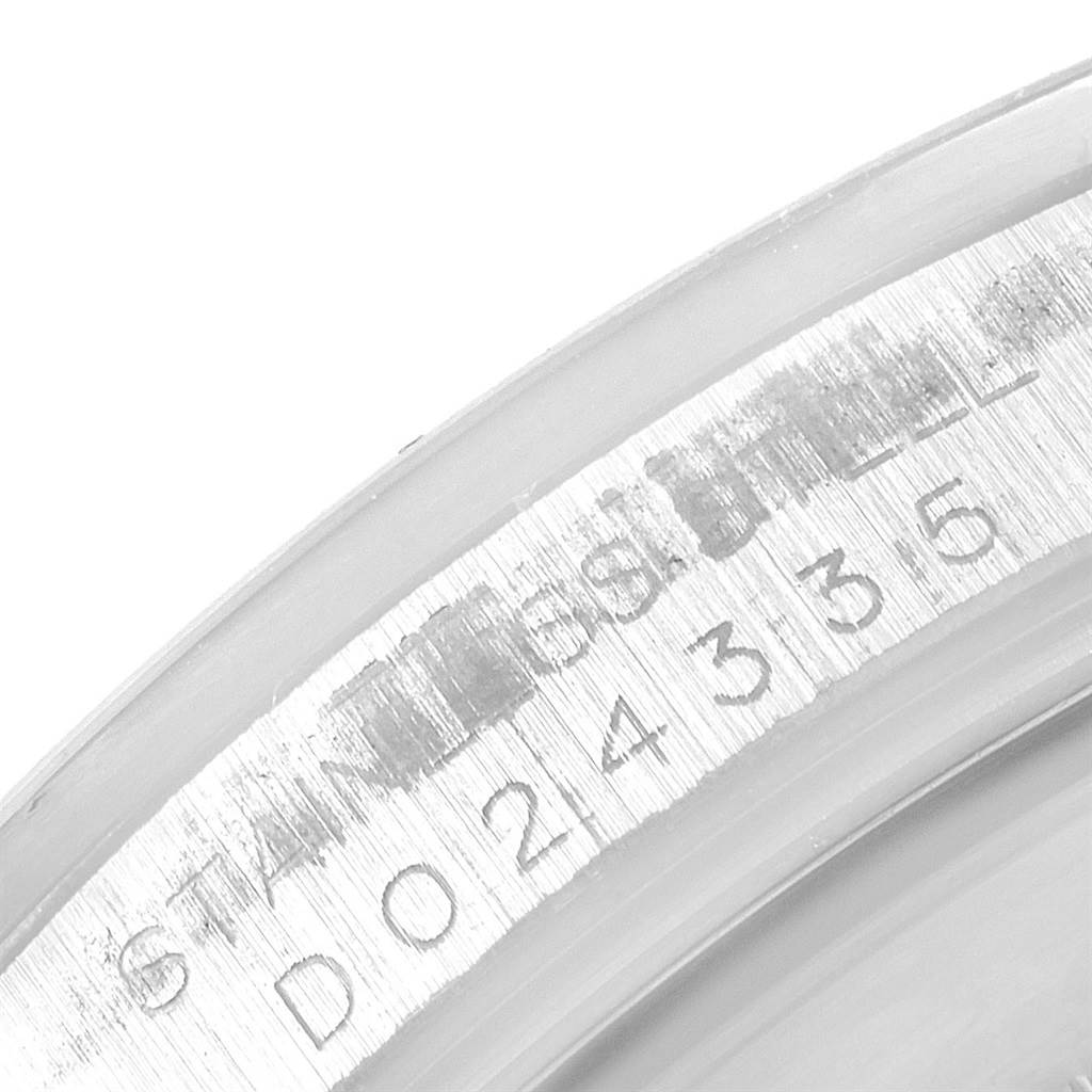 This image shows a close-up view of the serial number and "STAINLESS STEEL" engraving on a Rolex Explorer 16570 Men's Stainless Steel White Dial 16570 Men's Stainless Steel White Dial watch.