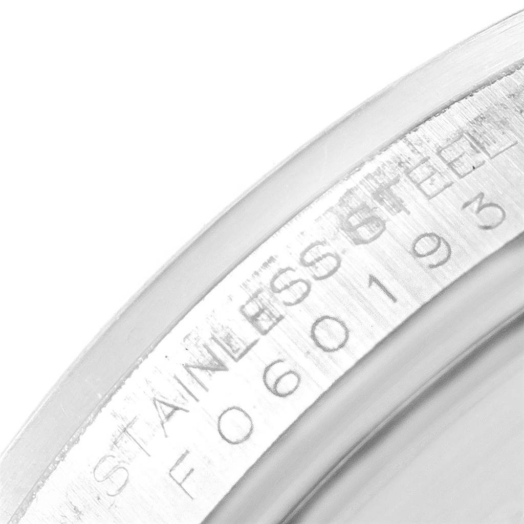 This image shows a close-up of the engraved serial number on the stainless steel case of a Rolex Explorer 16570 Men's Stainless Steel White Dial 16570 Men's Stainless Steel White Dial watch.