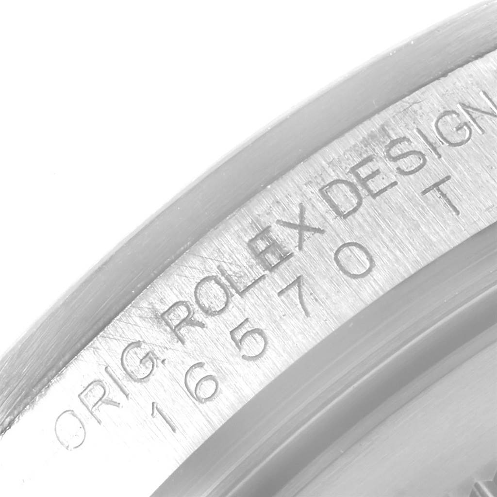 This image shows a close-up of the engravings on the inner bezel of a Rolex Explorer 16570 Men's Stainless Steel Black Dial 16570 Men's Stainless Steel Black Dial watch.