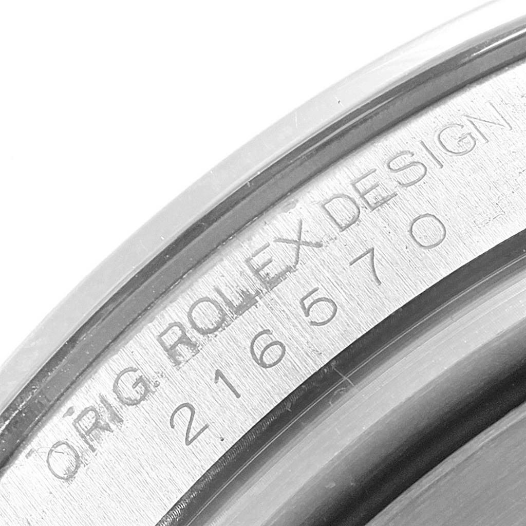 The image shows a close-up view of the inner case back rim of a Rolex Explorer 216570 Men's Stainless Steel Black Dial 216570 Men's Stainless Steel Black Dial, highlighting the "ORIG. ROLEX DESIGN 216570" engraving.
