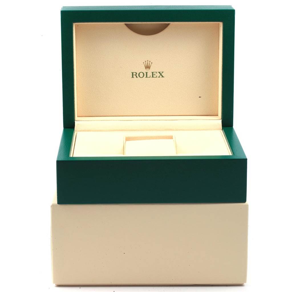 This image shows an open green and beige Rolex watch box, designed for the Explorer model.