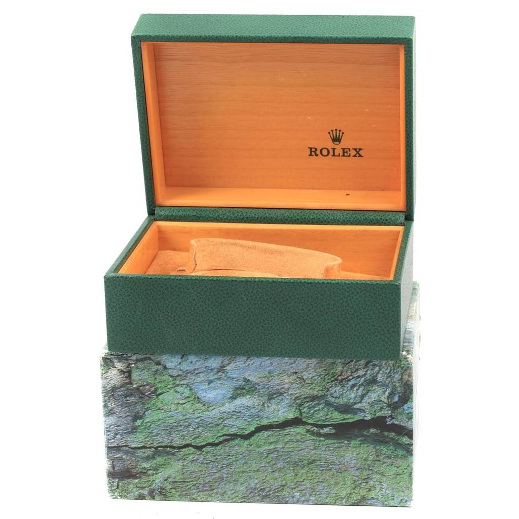 This image shows the open green box for a Rolex Explorer 16570 Men's Stainless Steel White Dial 16570 Men's Stainless Steel White Dial watch, revealing the wooden interior with the Rolex logo.