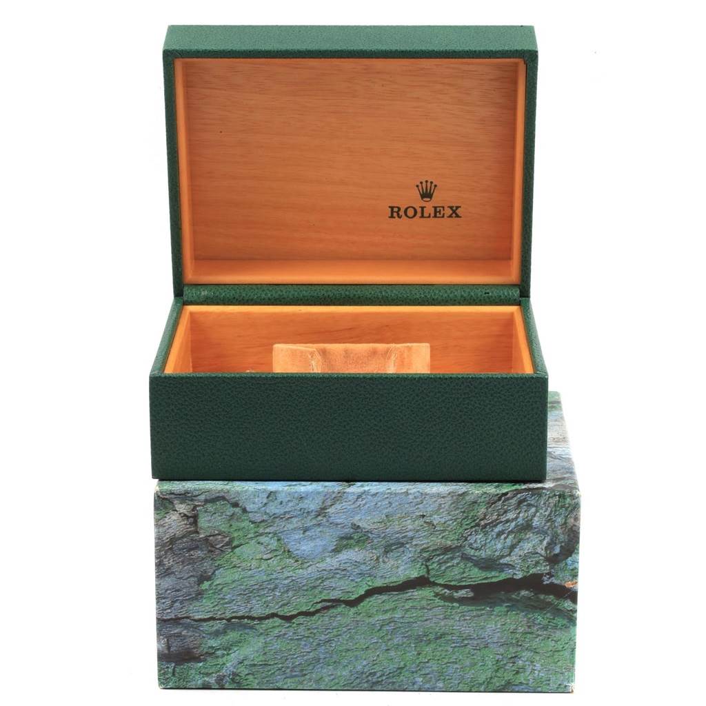 The image shows an open Rolex watch box, with the exterior green and interior wooden finish, intended for the Explorer model.