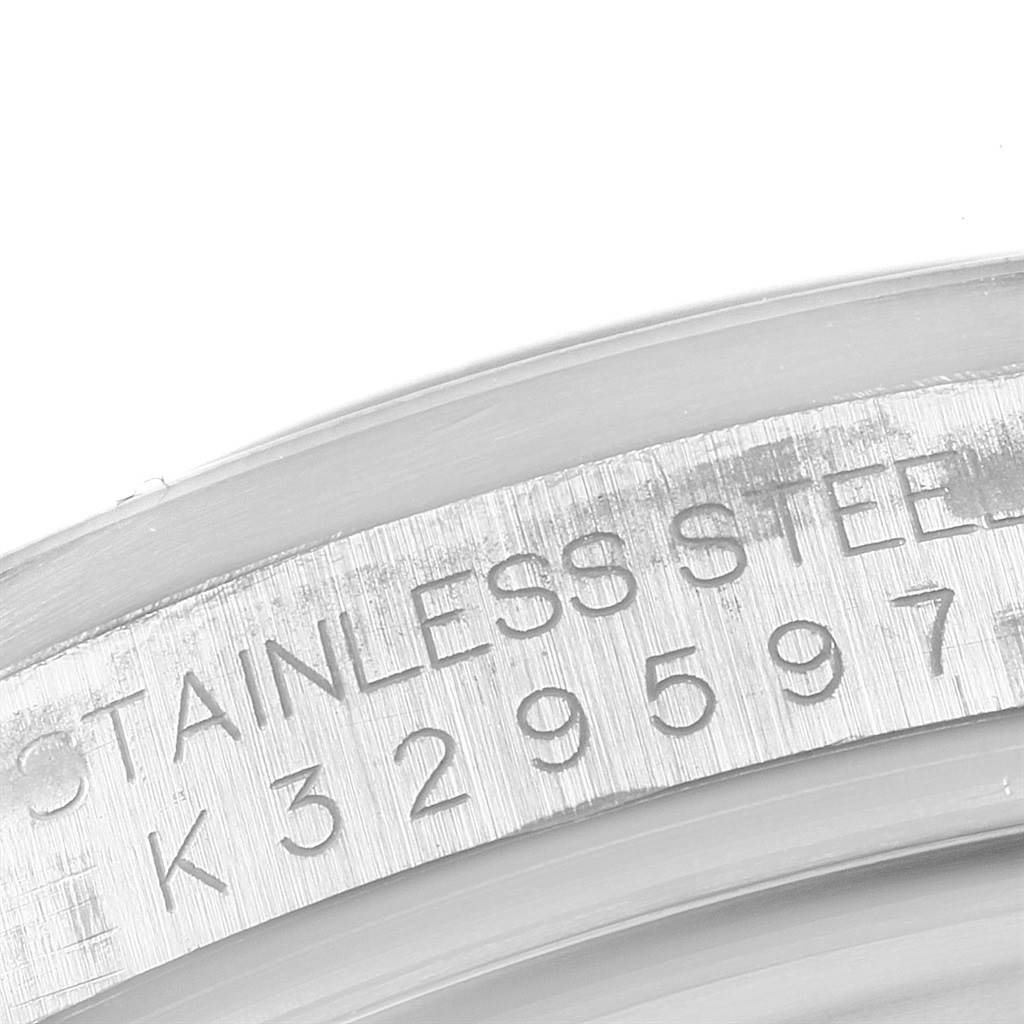 This image shows a close-up of the serial number and "STAINLESS STEEL" engraving on the caseback edge of a Rolex Explorer 16570 Men's Stainless Steel White Dial 16570 Men's Stainless Steel White Dial watch.