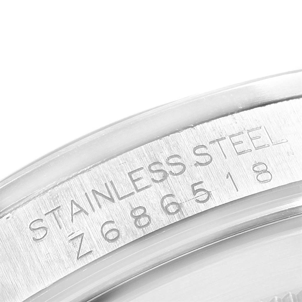 This image shows a close-up of the engraved serial number on the side of a stainless steel Rolex Explorer 16570 Men's Stainless Steel White Dial 16570 Men's Stainless Steel White Dial watch.