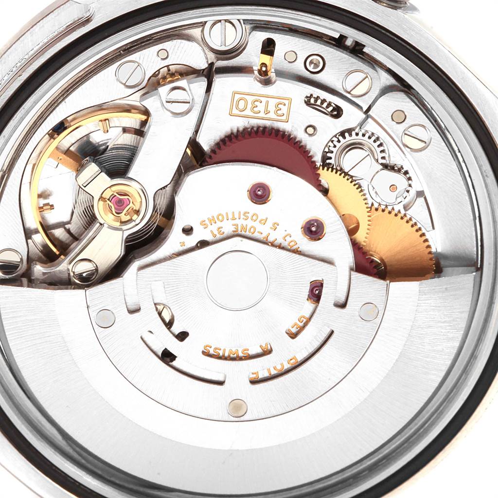 This image shows the intricate internal mechanics of a Rolex Explorer 114270 Men's Stainless Steel Black Dial 114270 Men's Stainless Steel Black Dial watch, highlighting its movement and gears.