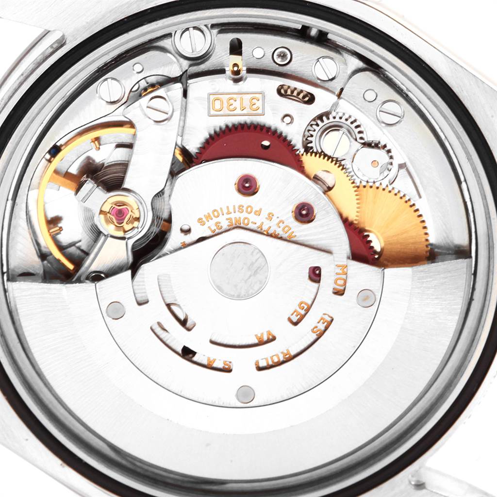 The image shows the backside of a Rolex Explorer 114270 Men's Stainless Steel Black Dial 114270 Men's Stainless Steel Black Dial watch displaying its intricate mechanical movement.